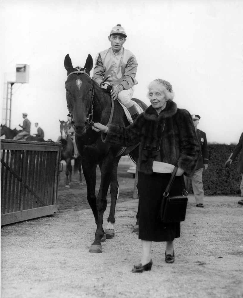 Bold Ruler (Eddie Arcaro up) being led to the winner's circle by owner Gladys Mills Phipps (Museum Collection)