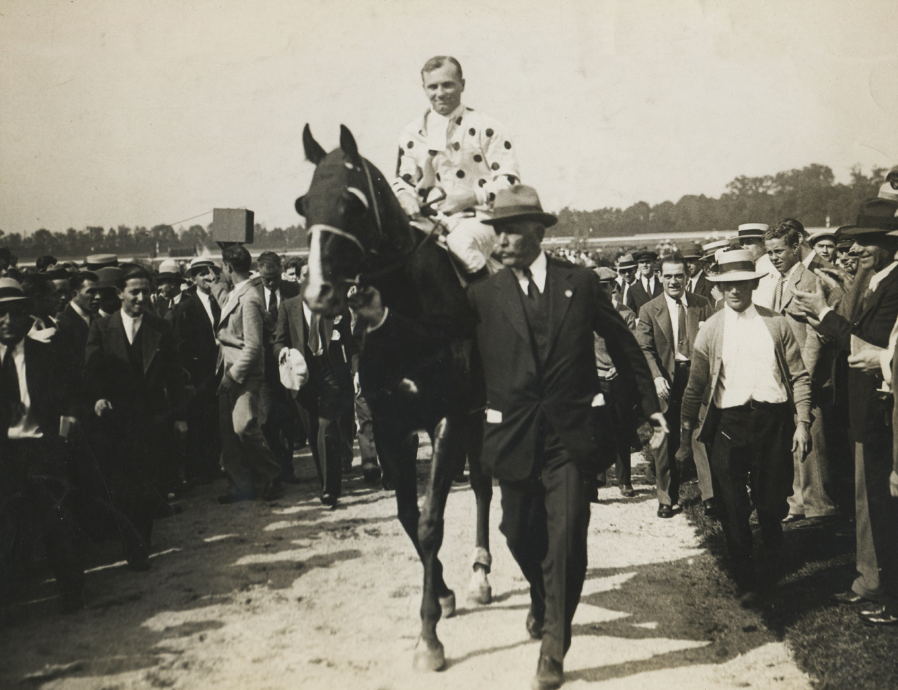 Owner William Woodward, Jr. leading in Gallant Fox (Earl Sande up) after winning the 1930 Lawrence Realization at Belmont Park (Museum Collection)