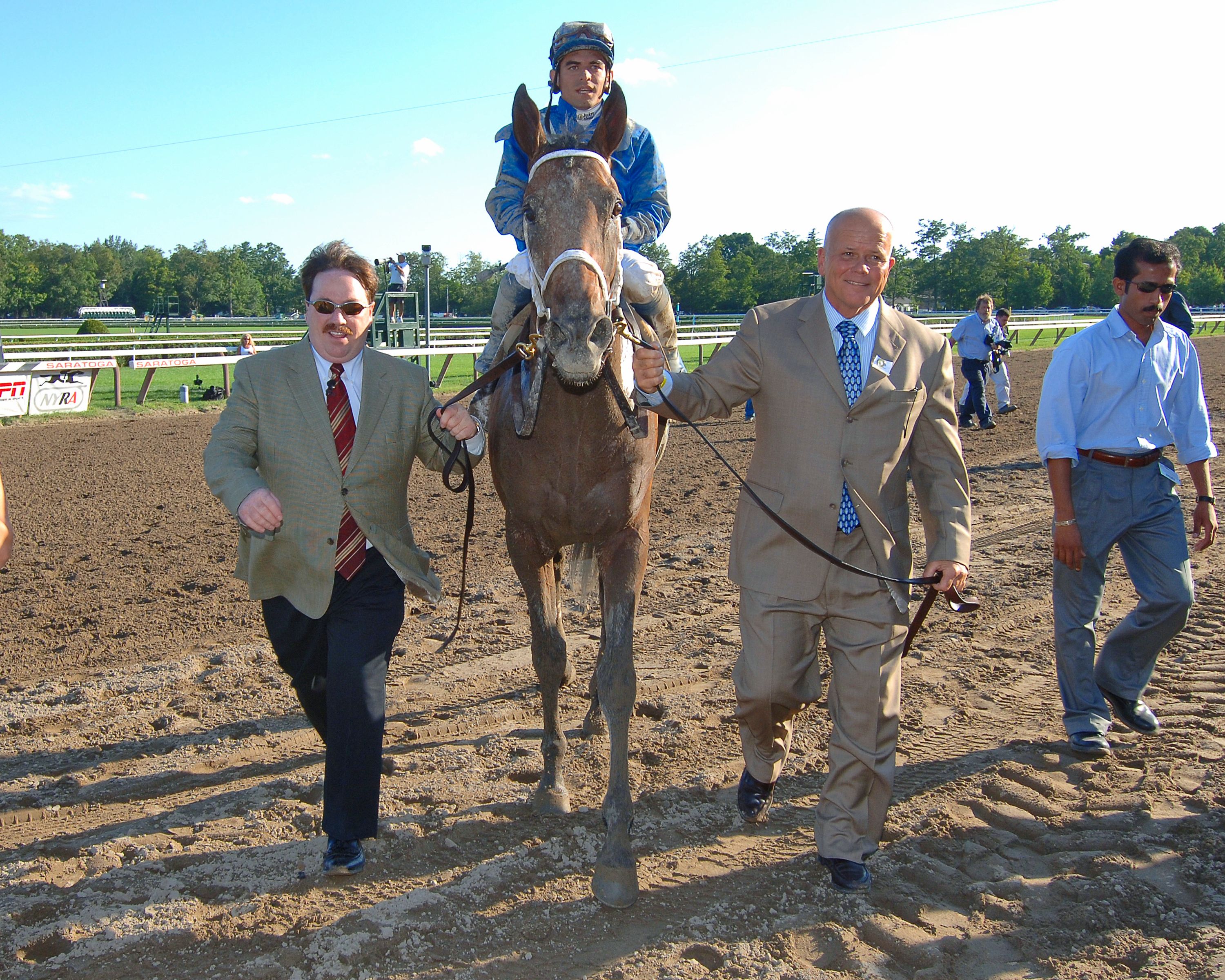 Invasor (Fernando Jara up) entering the winner's circle for the 2006 Whitney with Kiaran McLaughlin (left) and Rick Nichols (right) (NYRA)