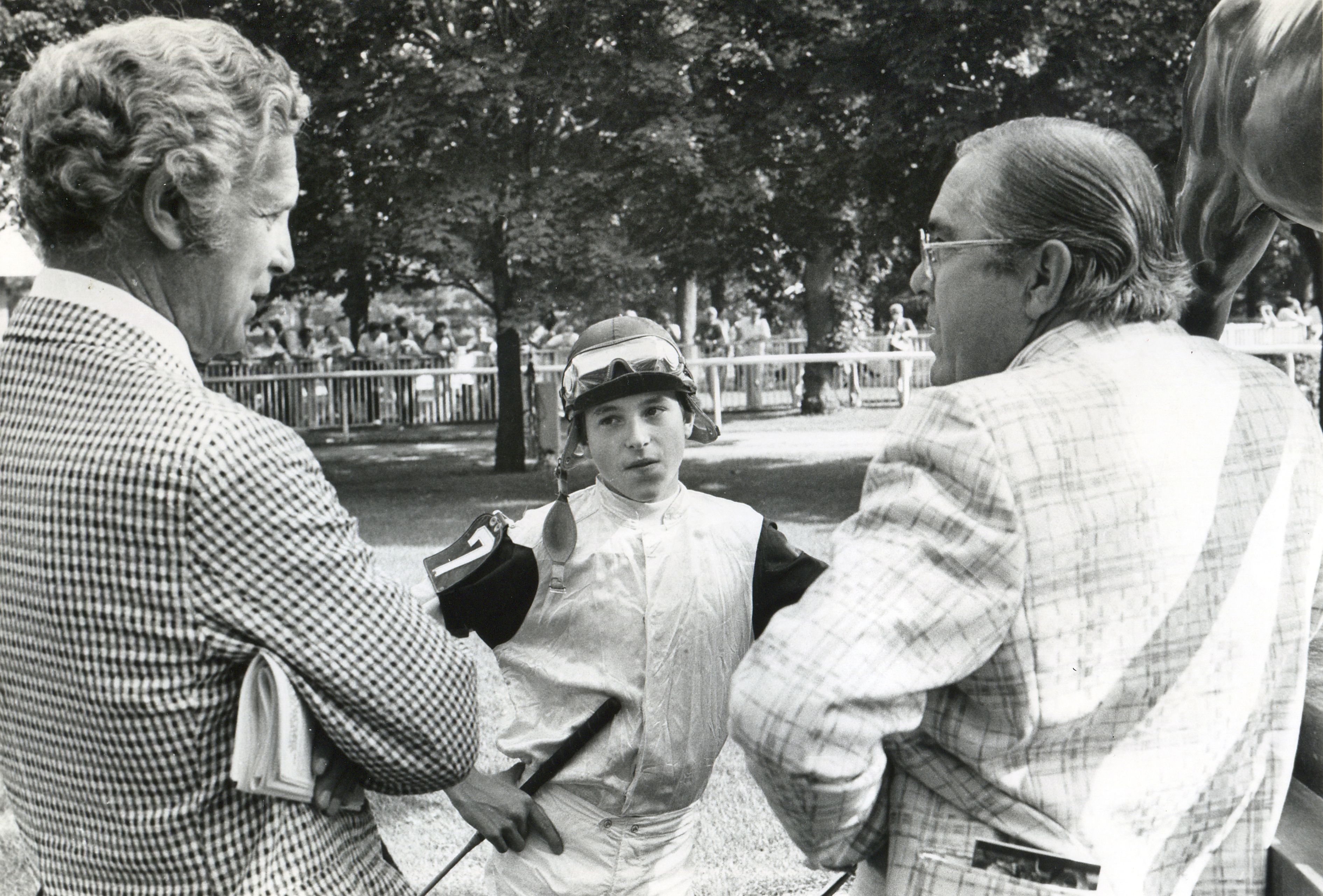 Lou Wolfson of Harbor View Farm, jockey Steve Cauthen, and Laz Barerra in the Belmont paddock before a race (NYRA/Photo Communications /Museum Collection)