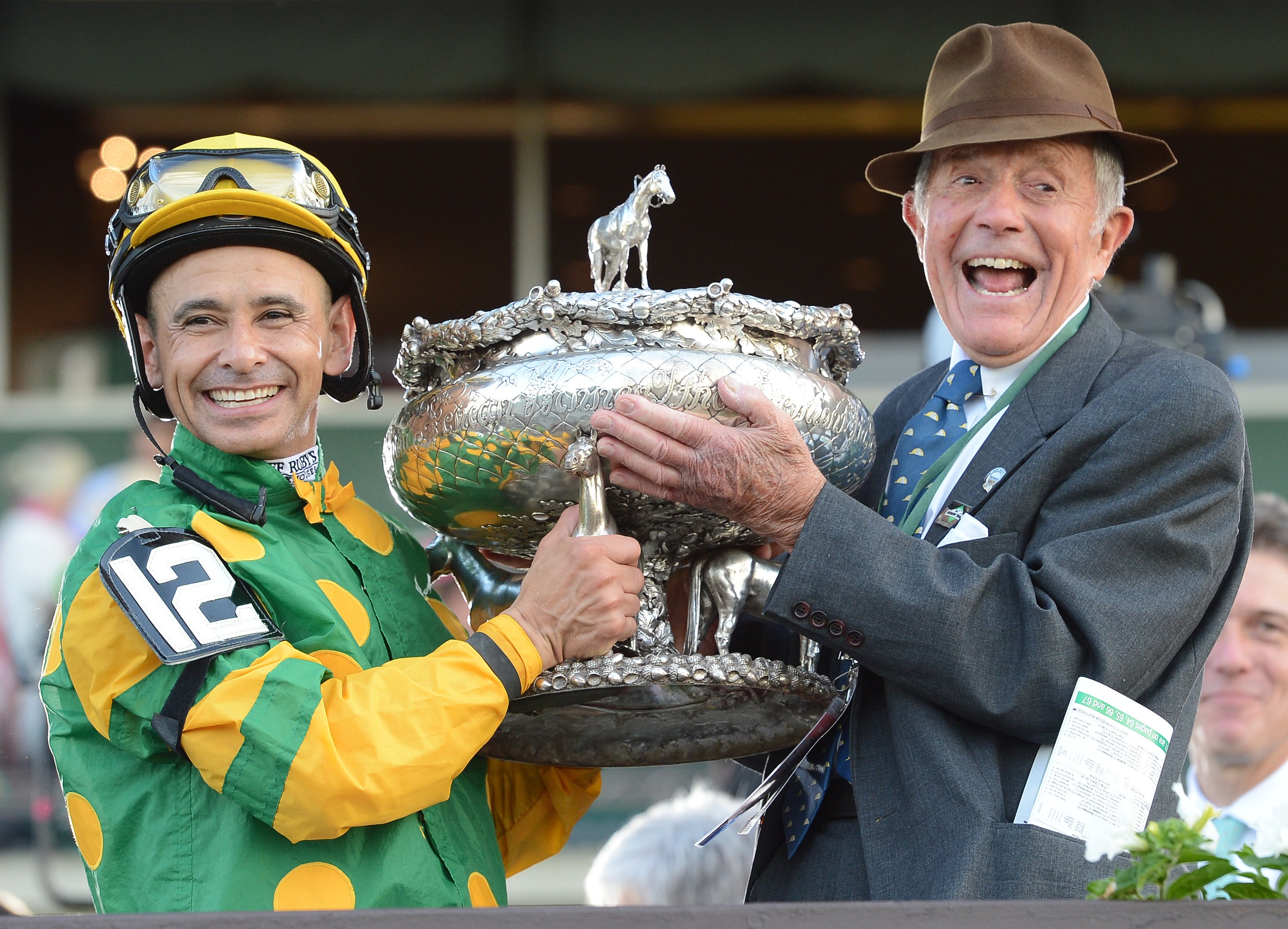 Mike Smith and Cot Campbell raise the August Belmont Memorial Trophy in celebration of Palace Malice's 2013 Belmont Stakes victory (NYRA)