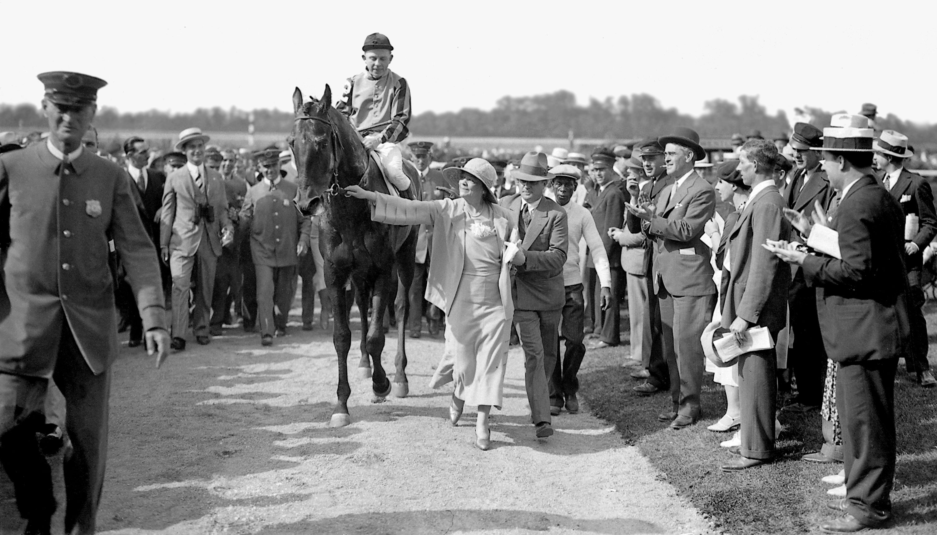 Helen Hay Whitney leading Twenty Grand, Charles Kurtsinger up, into the Belmont winner's circle (Keeneland Library Cook Collection)